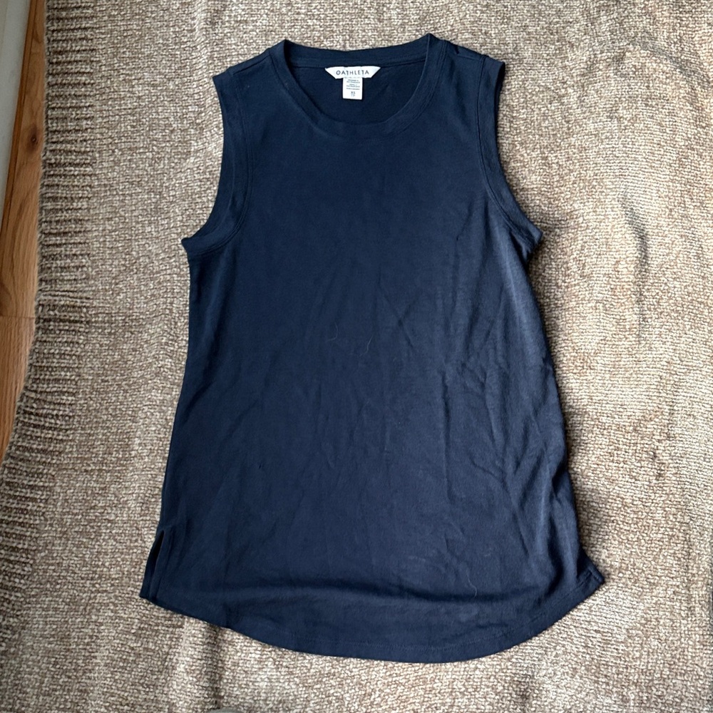 Longer sleeveless top in navy. Length is 25 inches